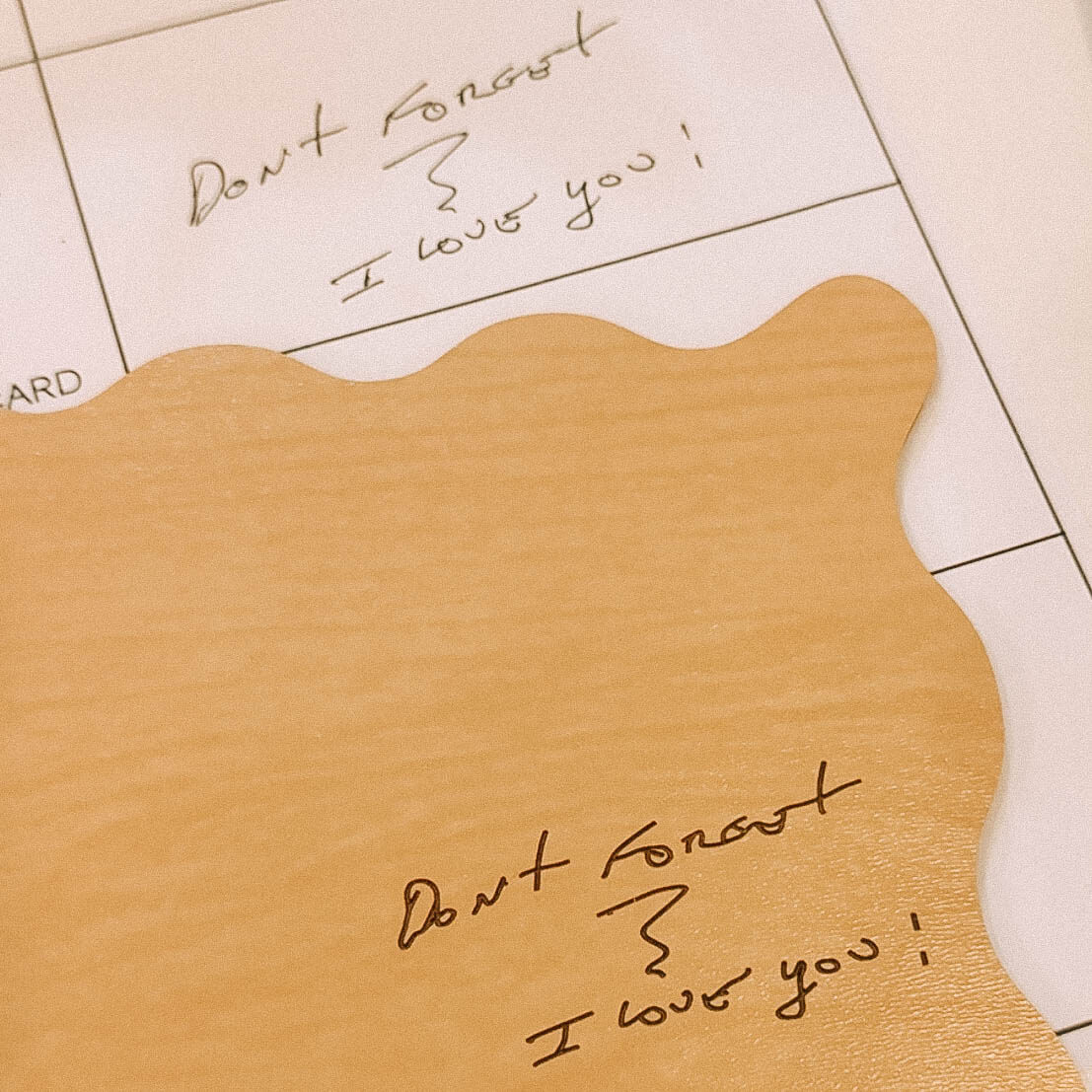 hand written message on paper and wooden board with the handwriting engraved